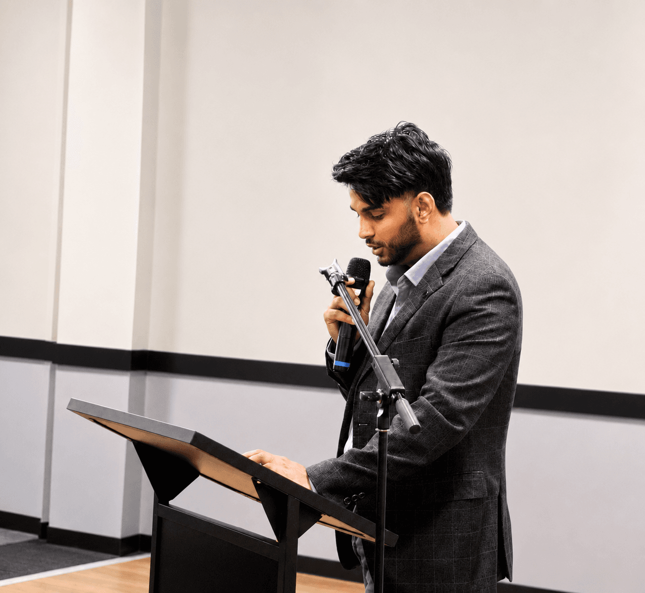 Babbal Khehra speaking at a lectern during a civic discussion